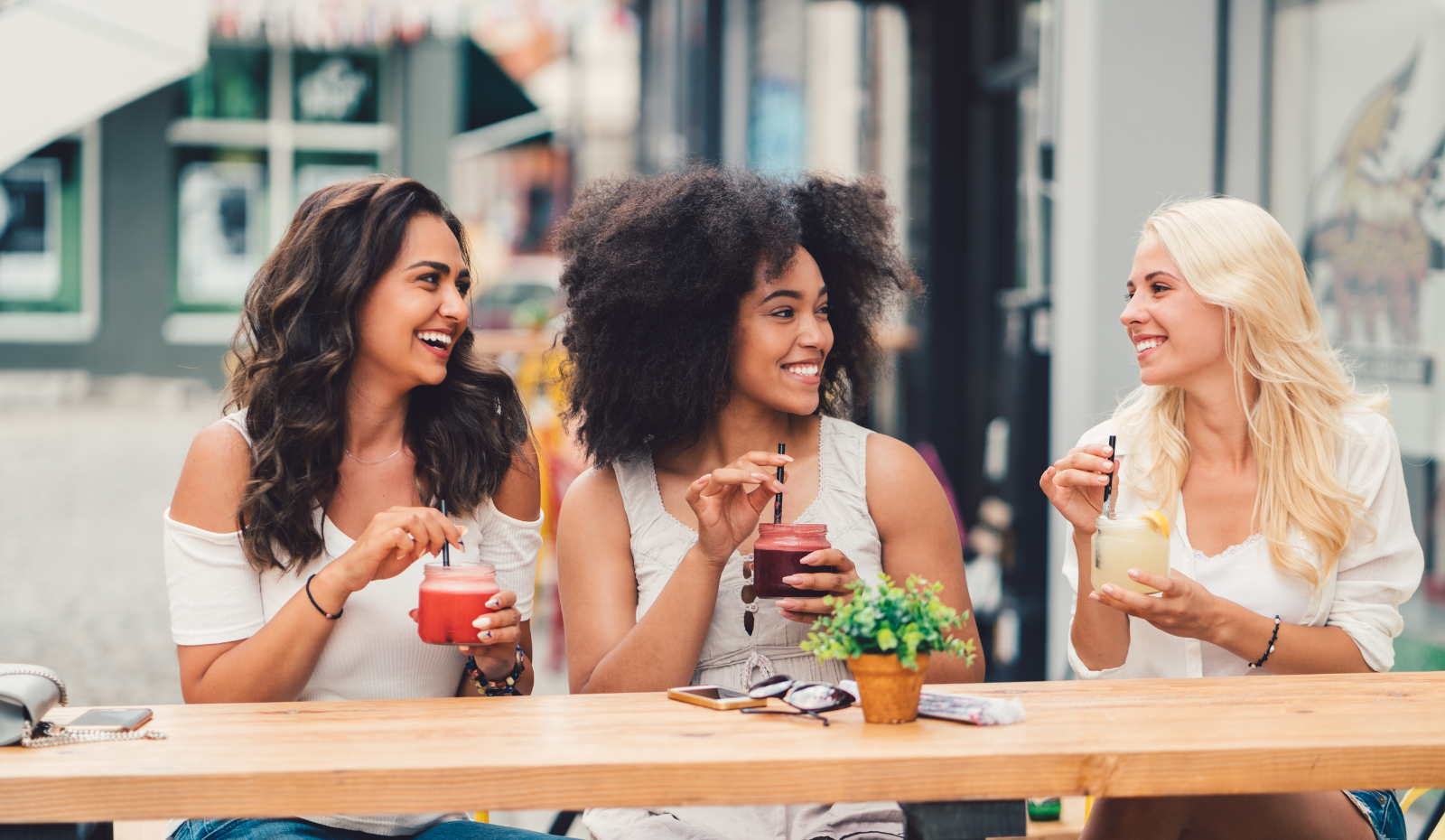 Friends at cafe drinking healthy smoothies. 