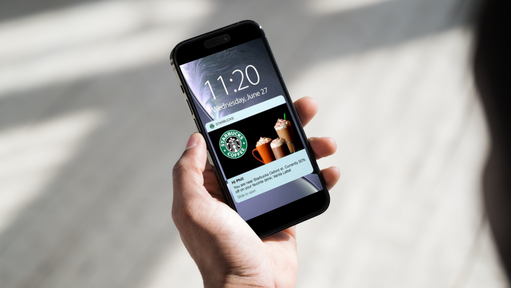 Phone with Starbucks' push notification on the screen. 